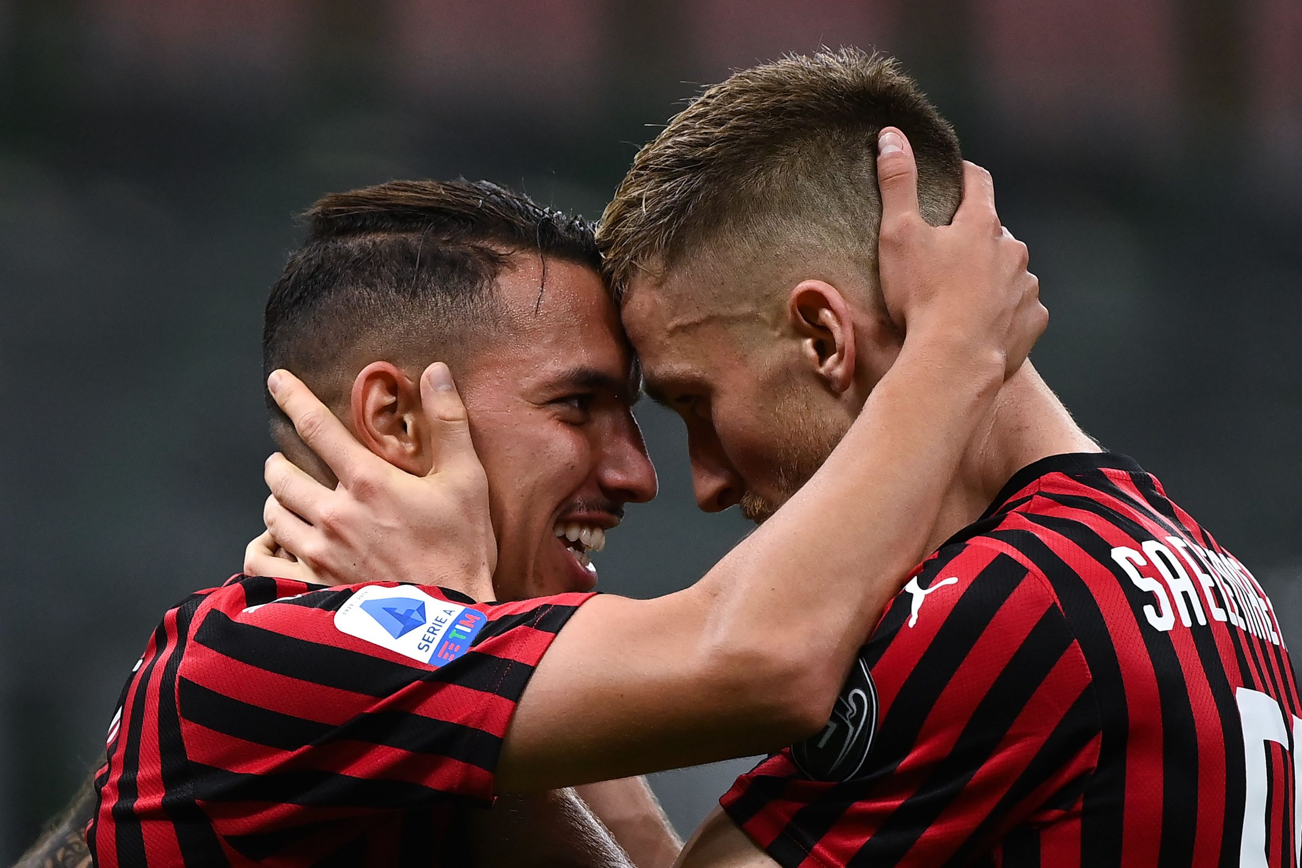 AC Milan's Algerian midfielder Ismael Bennacer (L) celebrates with AC Milan's Belgian midfielder Alexis Saelemaeker after scoring a goal during the Italian Serie A football match AC Milan vs Bologna played behind closed doors on July 15, 2020 at the San Siro Stadium in Milan, as the country eases its lockdown aimed at curbing the spread of the COVID-19 infection, caused by the novel coronavirus. (Photo by MARCO BERTORELLO / AFP) 