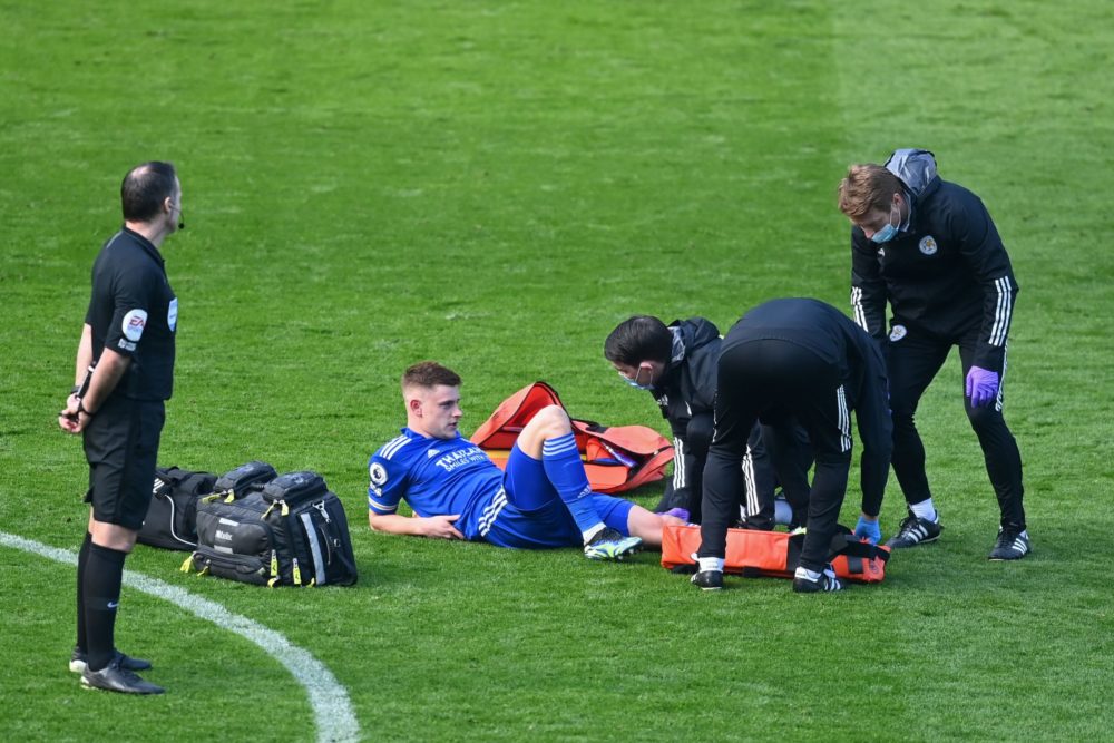 Leicester City's English midfielder Harvey Barnes is treated by medical staff after picking up an injury during the English Premier League football match between Leicester City and Arsenal at King Power Stadium in Leicester, central England on February 28, 2021. (Photo by Michael Regan / POOL / AFP)